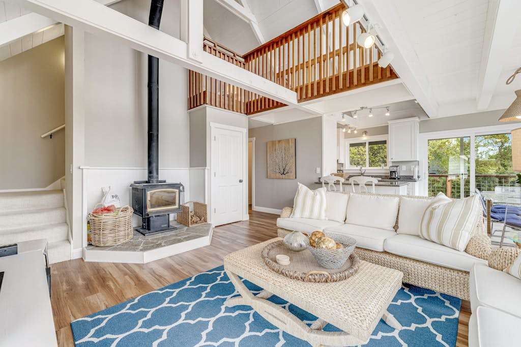 Settle into your sun-drenched great room where a crackling wood-burning stove, vaulted ceilings, and coastal blue accents set the tone for your Bodega Bay escape.