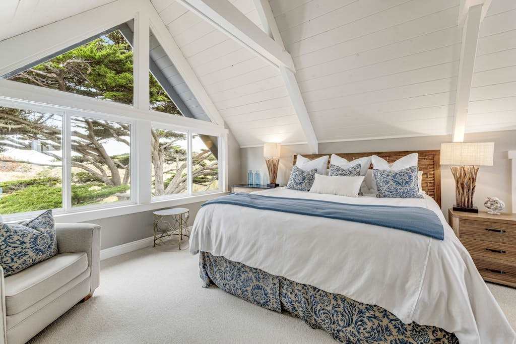 Wake to treetop views through dramatic A-frame windows in your master suite — natural light floods this loft retreat from every angle.