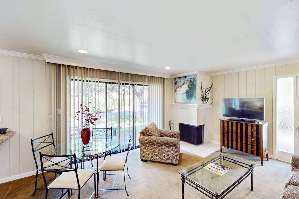 Gather around the glass dining table or lounge by the TV in your open-concept living space, with sliding doors framing views of Silverado's lush Napa Valley grounds.