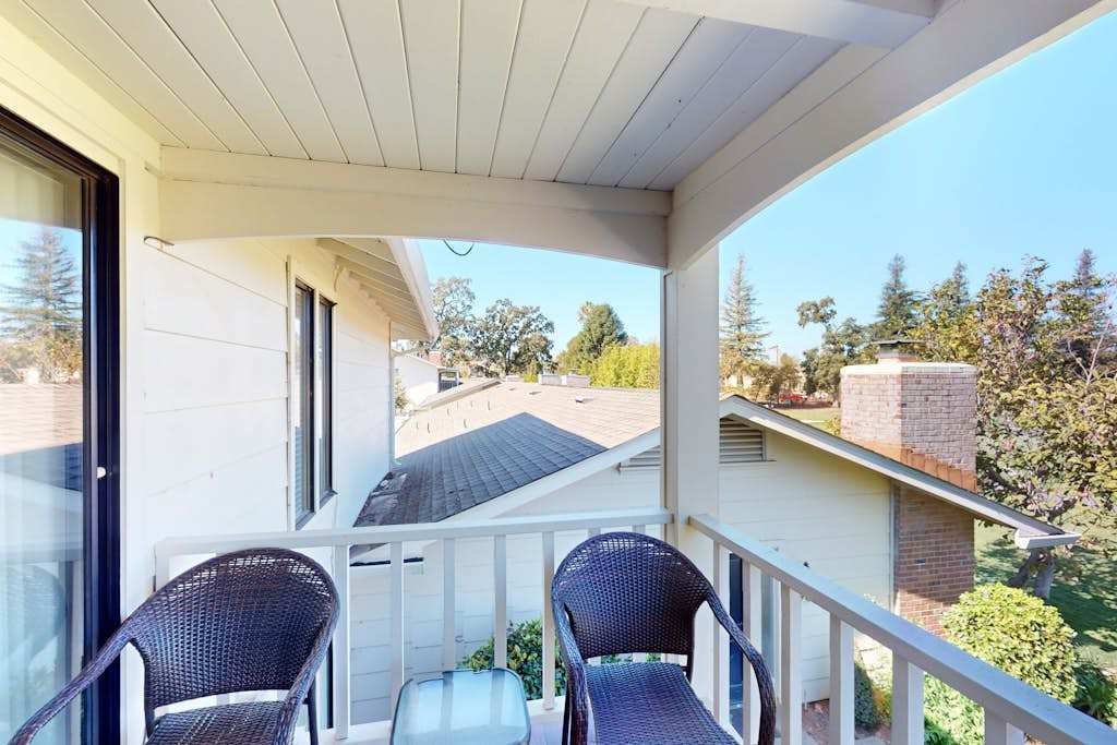 Savor your morning coffee on the covered balcony with wicker seating and views of the Silverado Resort treetops — a peaceful Napa start to every day.