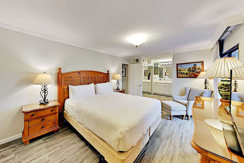 Sink into your plush king bed dressed in crisp white linens — this serene Napa Valley master suite is your ultimate wine country sanctuary.