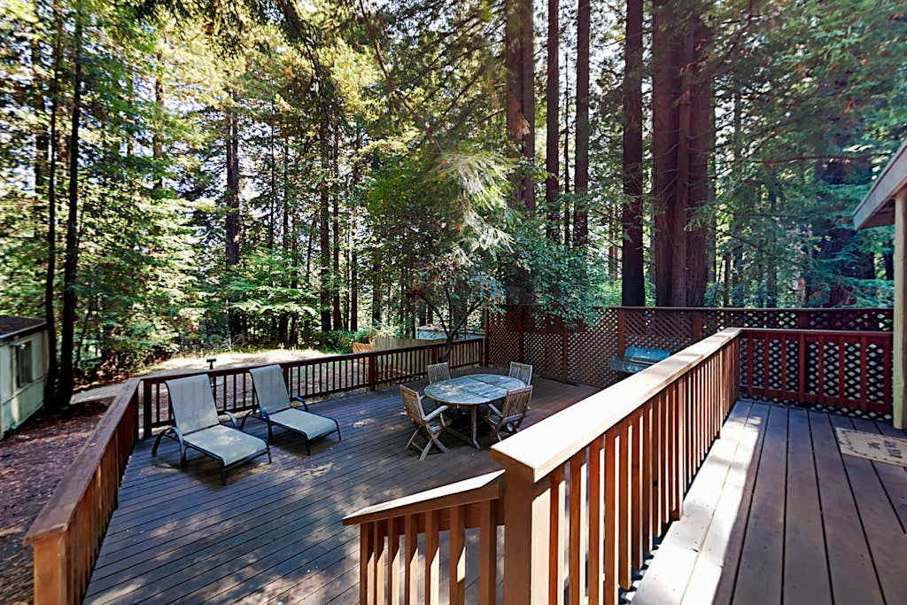 Settle into your private redwood canopy deck — lounge chairs and a dining set await your morning coffee among the towering trees of Cazadero.