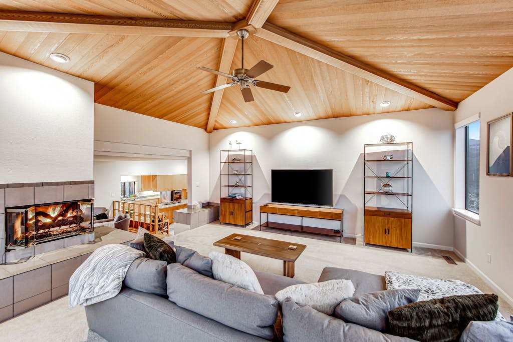 Cozy up for movie night with a large flat-screen TV, deep sectional seating, and your gas fireplace crackling just steps away