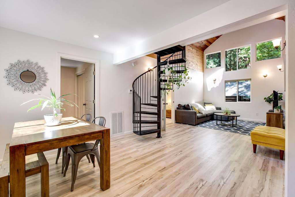 Gather your group around the farmhouse dining table in an open-concept layout where conversation flows from kitchen to living room beneath cathedral ceilings.