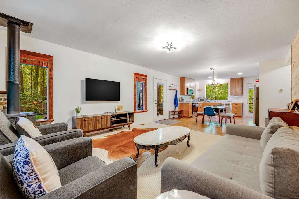 Stretch out in your open-concept living area with ample seating, a flat-screen TV, and a stylish cowhide rug — the kitchen is steps away for easy entertaining.
