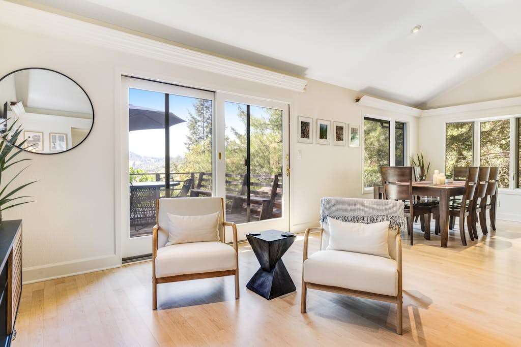 Gather your group in the open living and dining area where walls of glass reveal Sonoma County hillside views — an effortless setting for wine country entertaining.