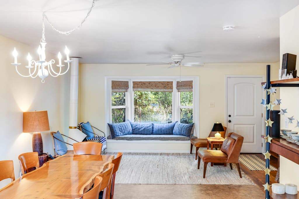 Relax in your airy living space where the cozy window nook and elegant chandelier create the ultimate wine country reading corner