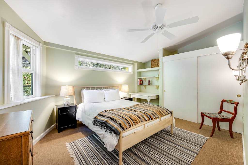 Drift off in your serene master bedroom with plush queen bed, built-in shelving, and a ceiling fan for year-round Cloverdale comfort
