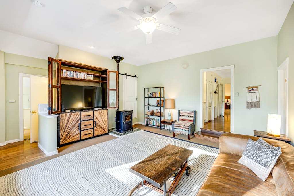 Settle into your sun-filled living room with rustic barn-door entertainment center, wood stove, and hardwood floors perfect after a day of wine tasting