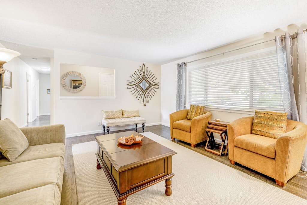 Gather your group in the sunlit sitting area — accent chairs and a picture window create the perfect spot to plan your Sonoma Valley vineyard itinerary.