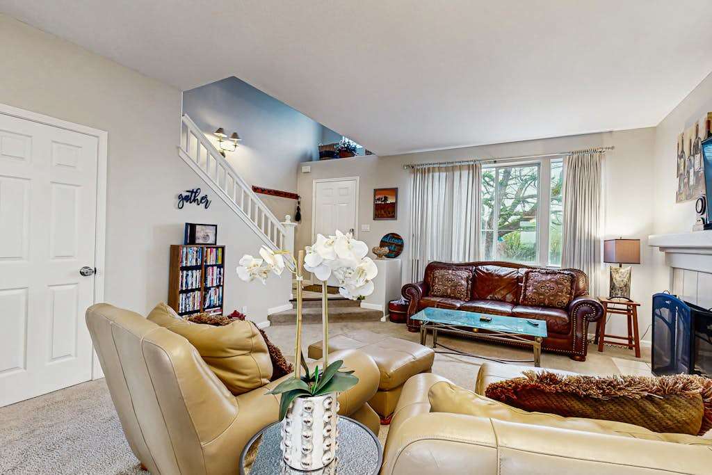 Gather your group in this inviting living space with ample seating, a curated bookshelf, and elegant orchid accents — ideal for planning your next wine country adventure.
