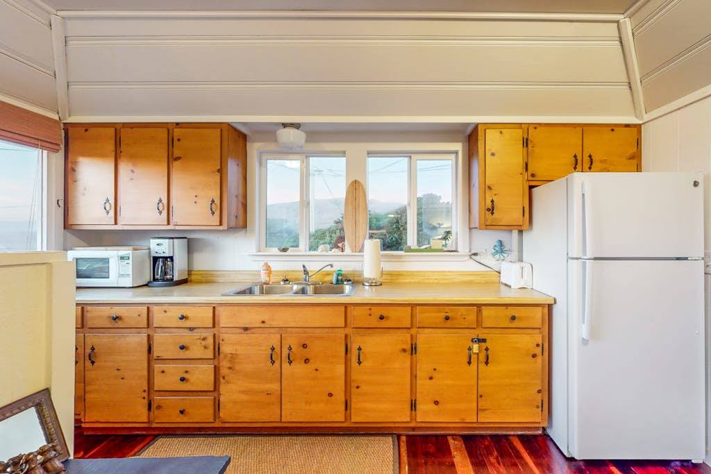 Brew your morning coffee with a view in this fully equipped Bodega Bay kitchen — warm wood cabinetry and everything you need to cook fresh Sonoma County fare.