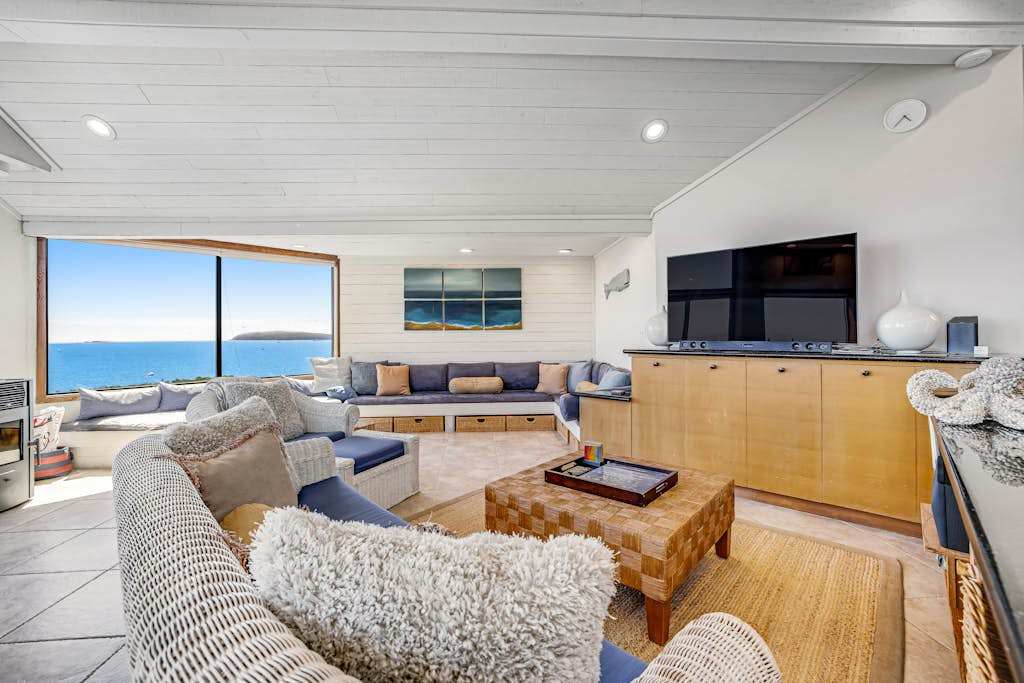 Gather your group around the big-screen TV or simply gaze at the Pacific — your spacious living room delivers both movie nights and ocean magic