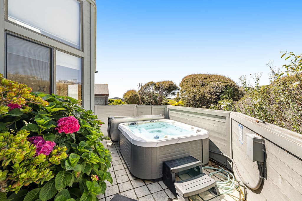 Soak away the sea breeze chill in your private hot tub surrounded by blooming hydrangeas — the perfect Bodega Bay wind-down after a day of coastal exploring