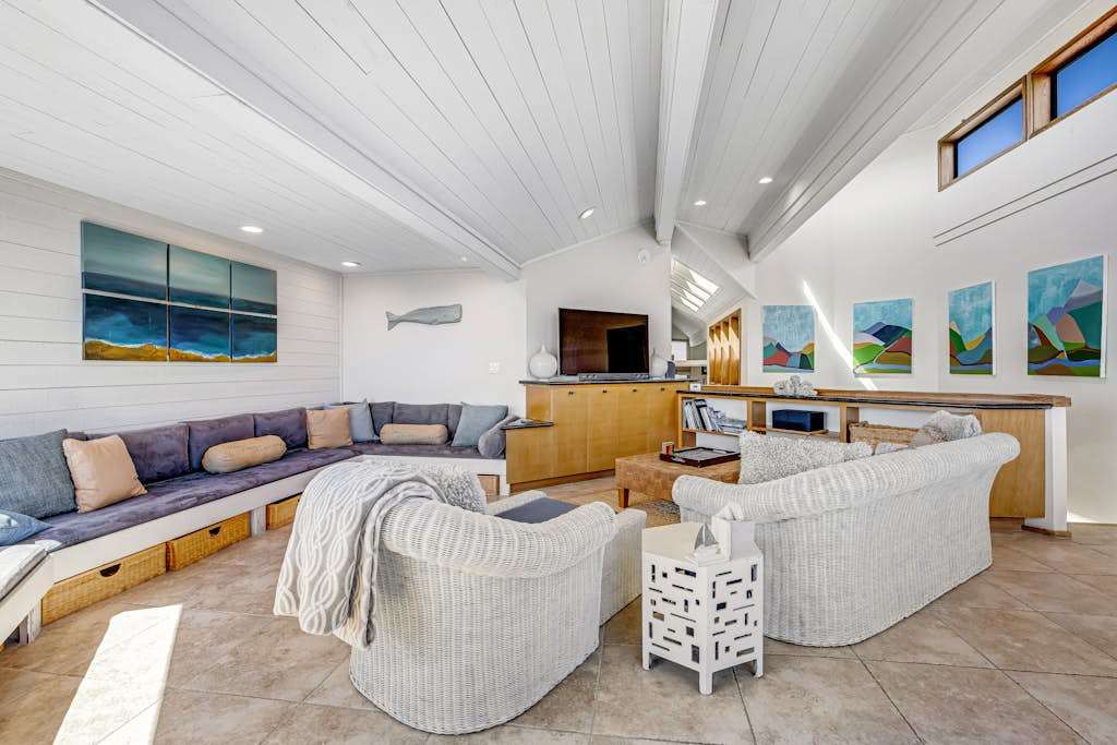 Local coastal artwork lines your vaulted-ceiling retreat, with built-in bench seating that invites lingering conversations after long Sonoma Coast days