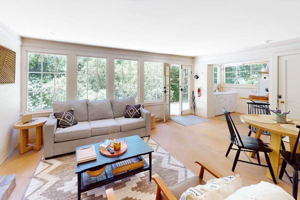 Natural light pours through your open-plan living and dining area where French doors lead straight to the patio — the redwood forest is never more than a glance away.