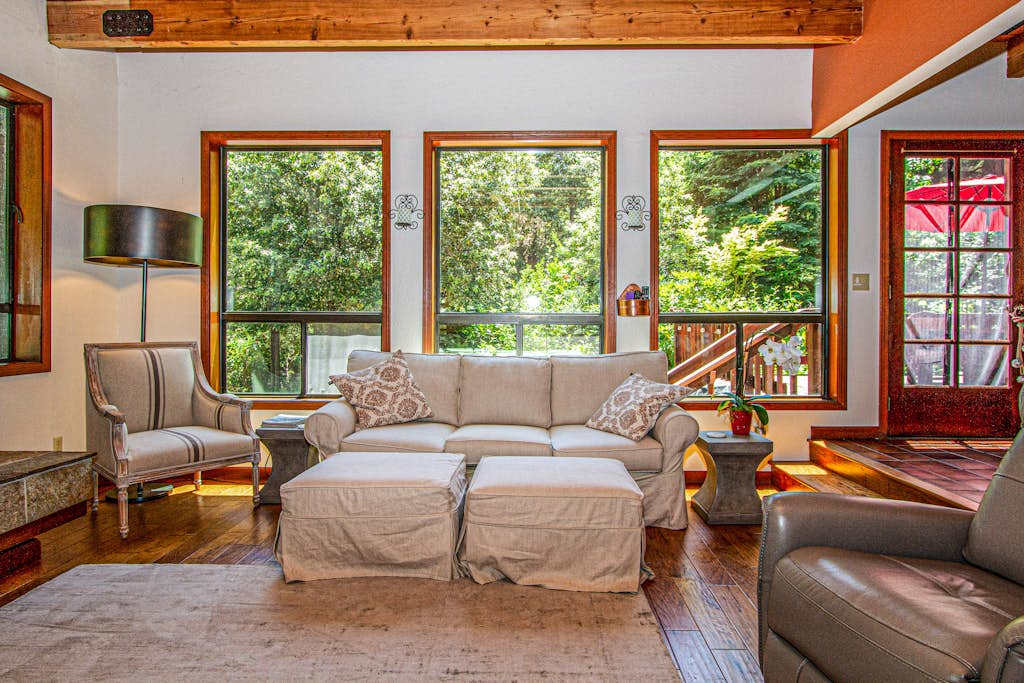 Sunlight pours through oversized windows into your living room, framing lush redwood views while you stretch out on the comfy sofa after a day exploring Sonoma.