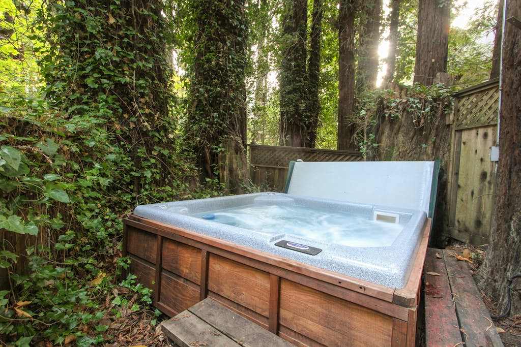 Your bubbling hot tub is draped in ivy and tucked among the trees — the ultimate way to unwind after a day of Sonoma County wine tasting.