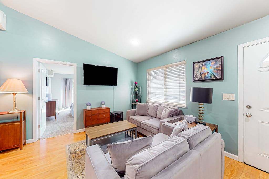 Sink into your plush sofa and stream your favorites on the wall-mounted TV — this sunlit living room with hardwood floors is your cozy basecamp between Russian River adventures.