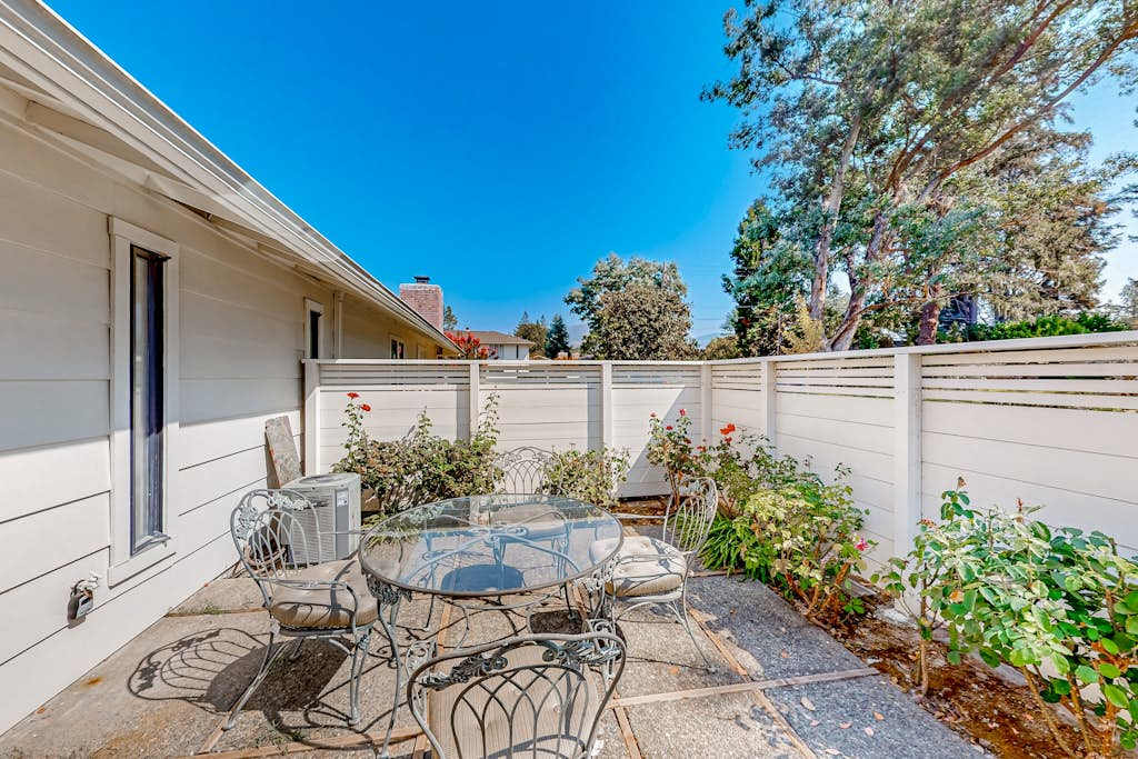 Savor your morning coffee on your private patio with wrought iron bistro seating, blooming roses, and Napa Valley sunshine at your doorstep
