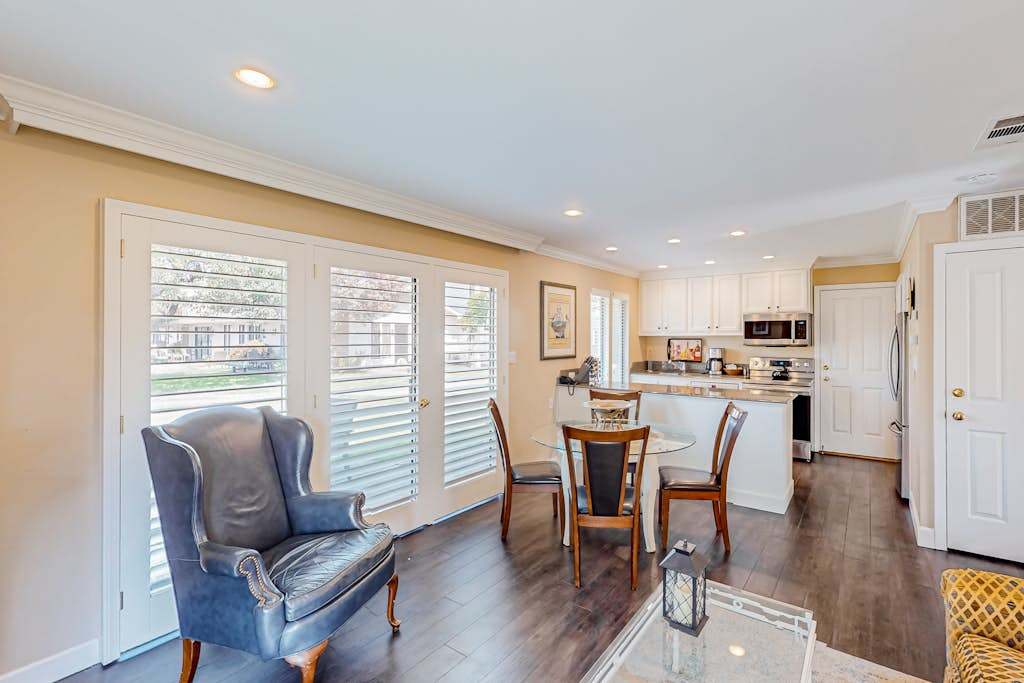 Gather around the dining table bathed in natural light through plantation shutters — an inviting spot to plan your next Napa winery visit over morning coffee.