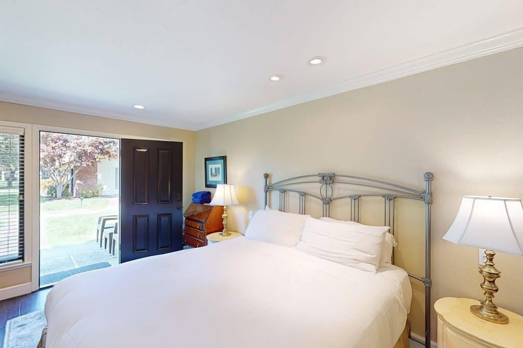Wake up to natural light streaming through your bedroom's sliding glass door — step right outside onto the resort grounds to start your Napa morning.