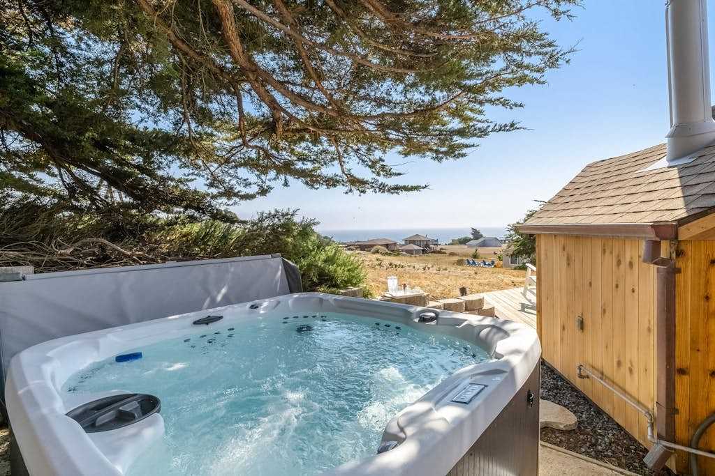 Melt away the day in your private hot tub tucked beneath coastal cypress trees, with Pacific breezes and ocean views as your backdrop