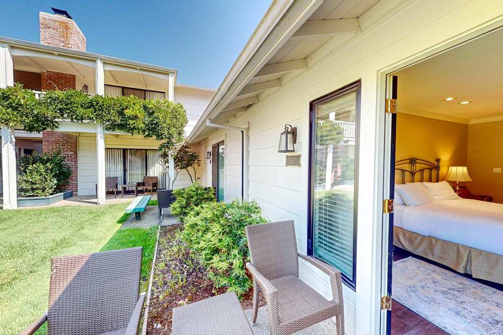 Step onto your private ground-level patio with wicker seating and take in the manicured resort lawn — your bedroom is just a sliding door away.