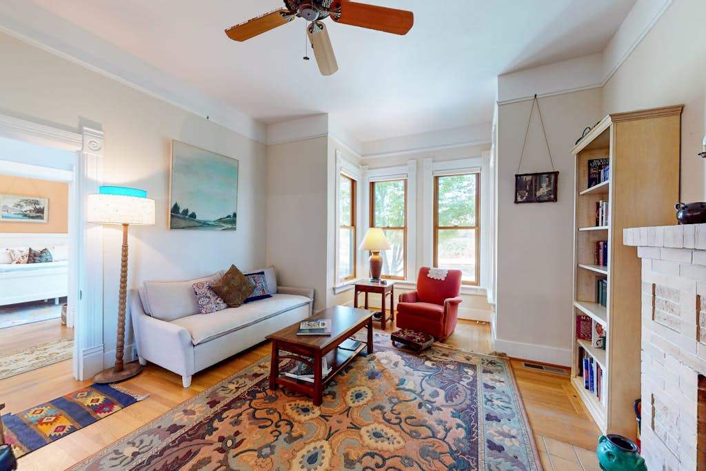 Unwind in your sun-filled living room with a good book from the built-in shelf — bay windows flood this Healdsburg retreat with natural light.
