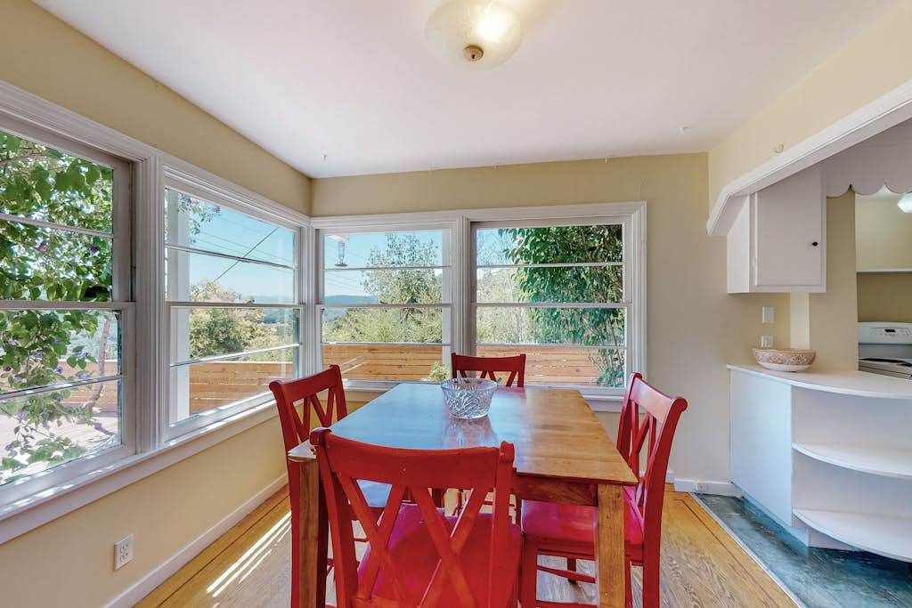Linger over breakfast at your charming farmhouse dining table — sunlight pours through panoramic windows framing Healdsburg's rolling green hills.