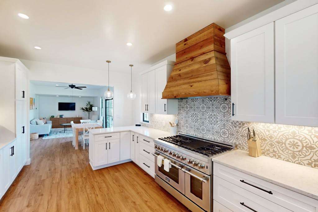 Fire up the professional-style gas range beneath a gorgeous reclaimed wood hood — patterned tile and gleaming quartz create your dream kitchen for crafting wine-paired dinners.