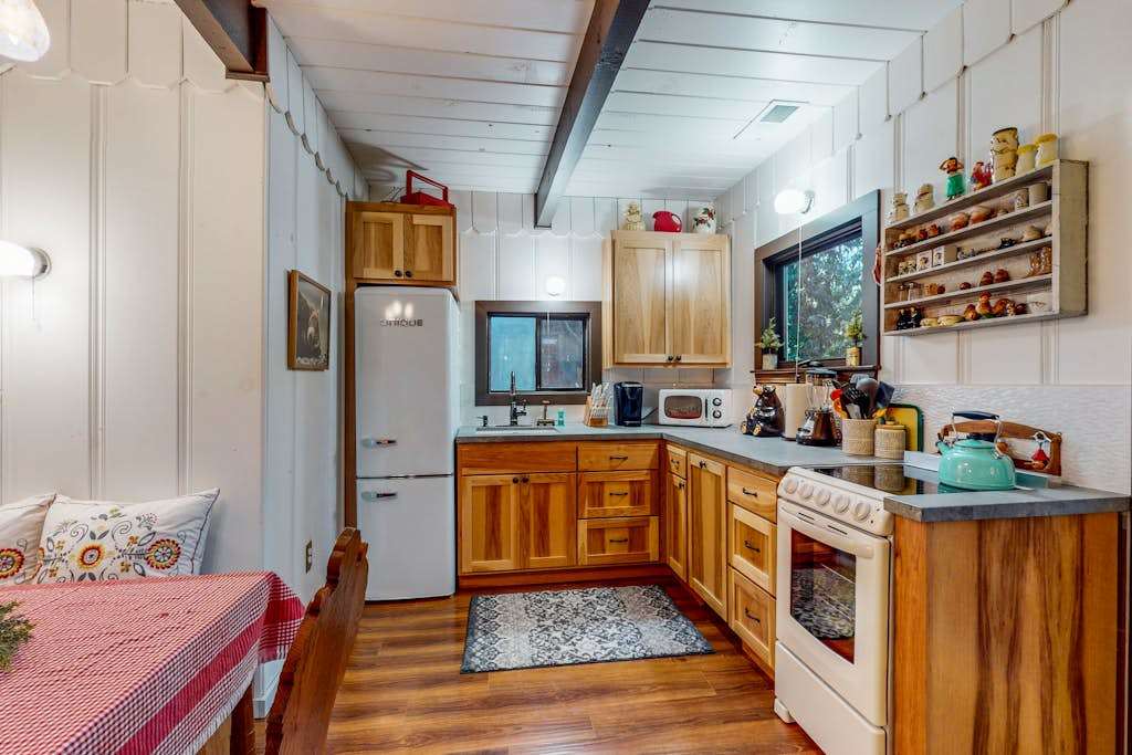 Your fully stocked galley kitchen features warm wood cabinetry, a gas stove, oven, microwave, and ample counter space — everything you need to cook with local Sonoma ingredients.
