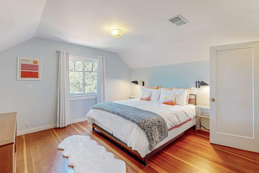 Wake to natural light beneath the vaulted ceiling of your airy Healdsburg retreat — hardwood floors and soft textiles create a restful wine country sanctuary.