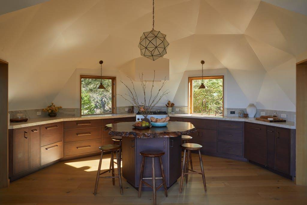 Craft culinary delights in this modern kitchen, where natural light pours in, making meal prep a joyful experience with stunning views to inspire you.