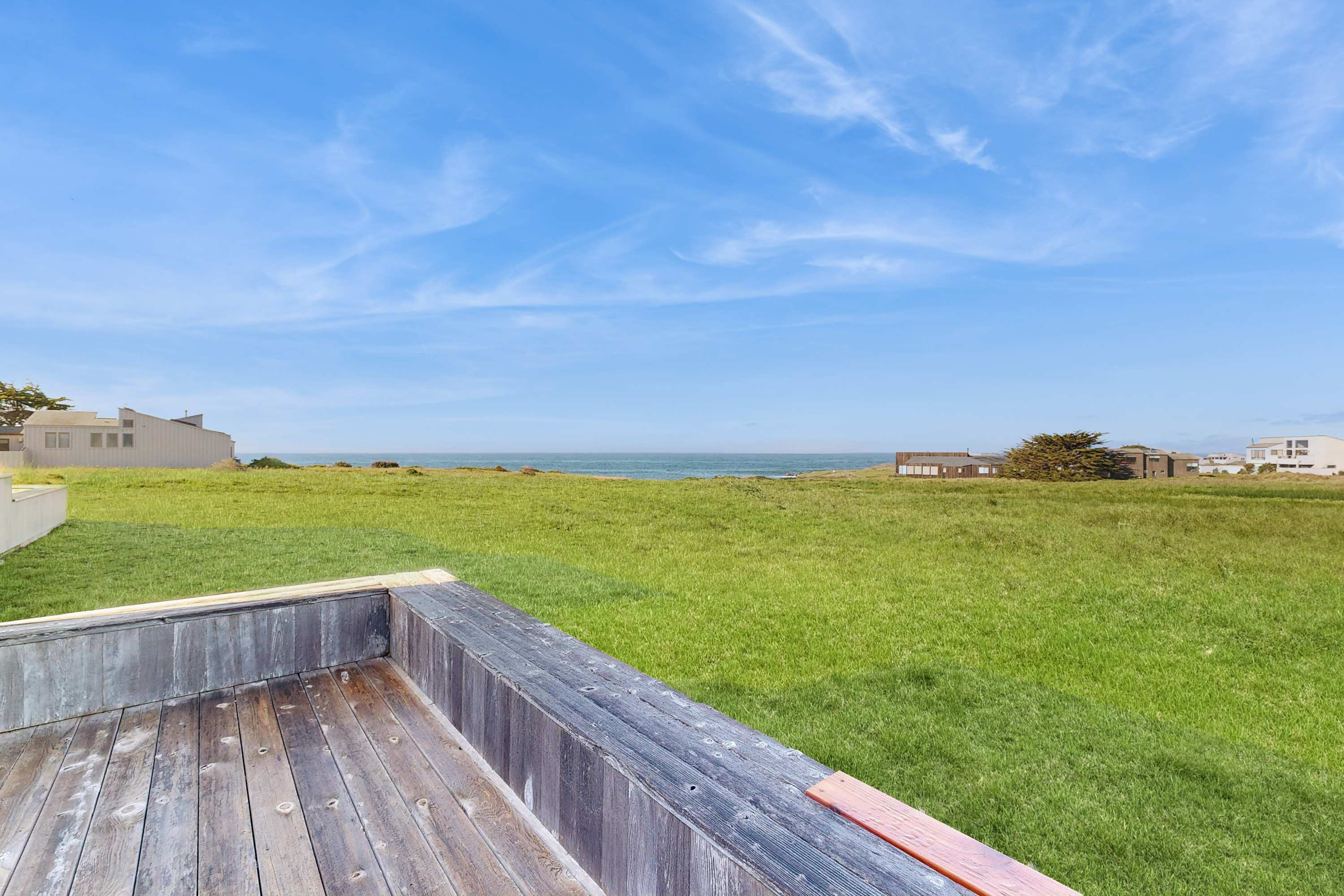 The view from the deck says it all -- unobstructed ocean views across a green meadow, stretching all the way to the Pacific horizon.
