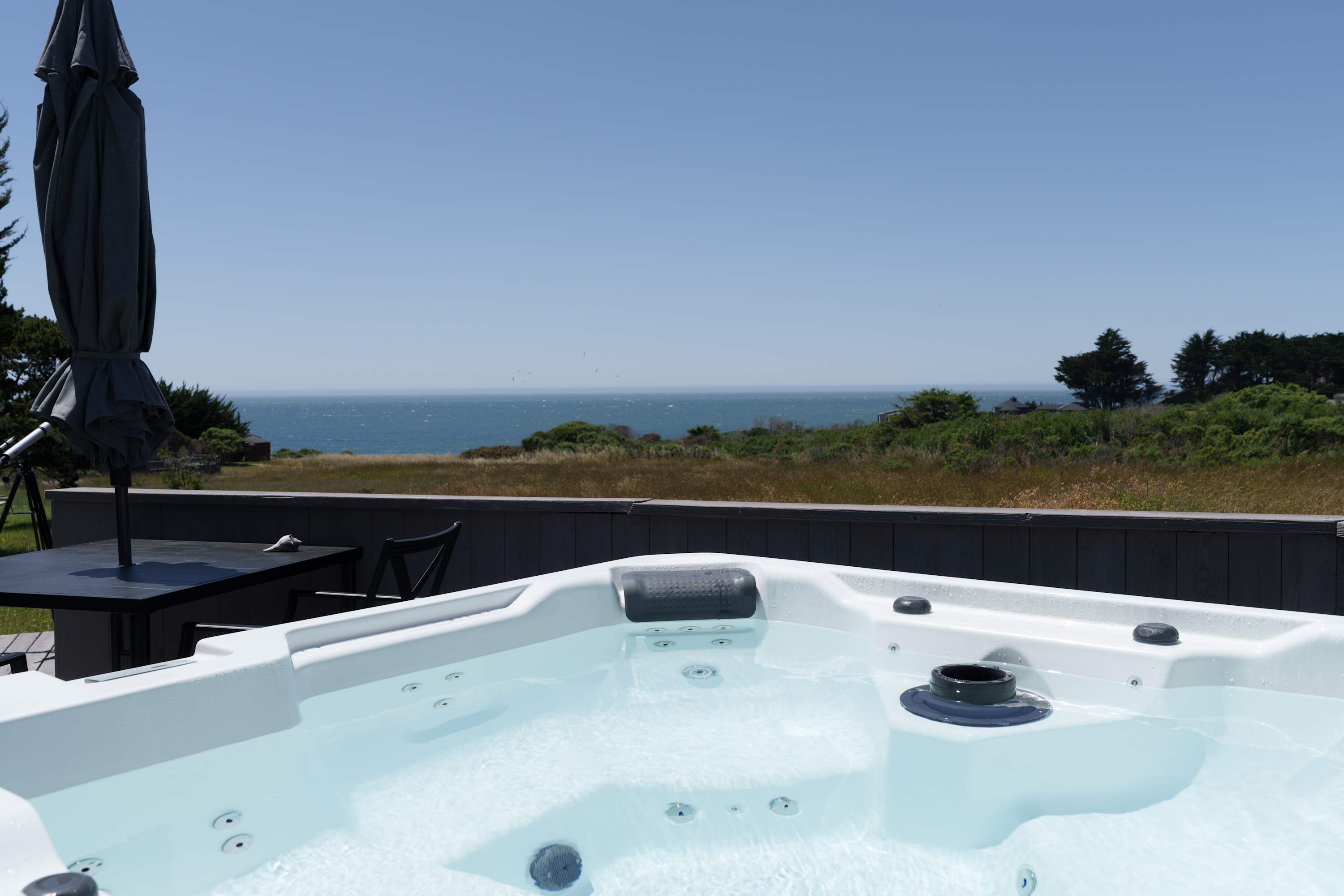 Soak in the bubbling hot tub on a private deck while taking in sweeping ocean views and coastal scenery.