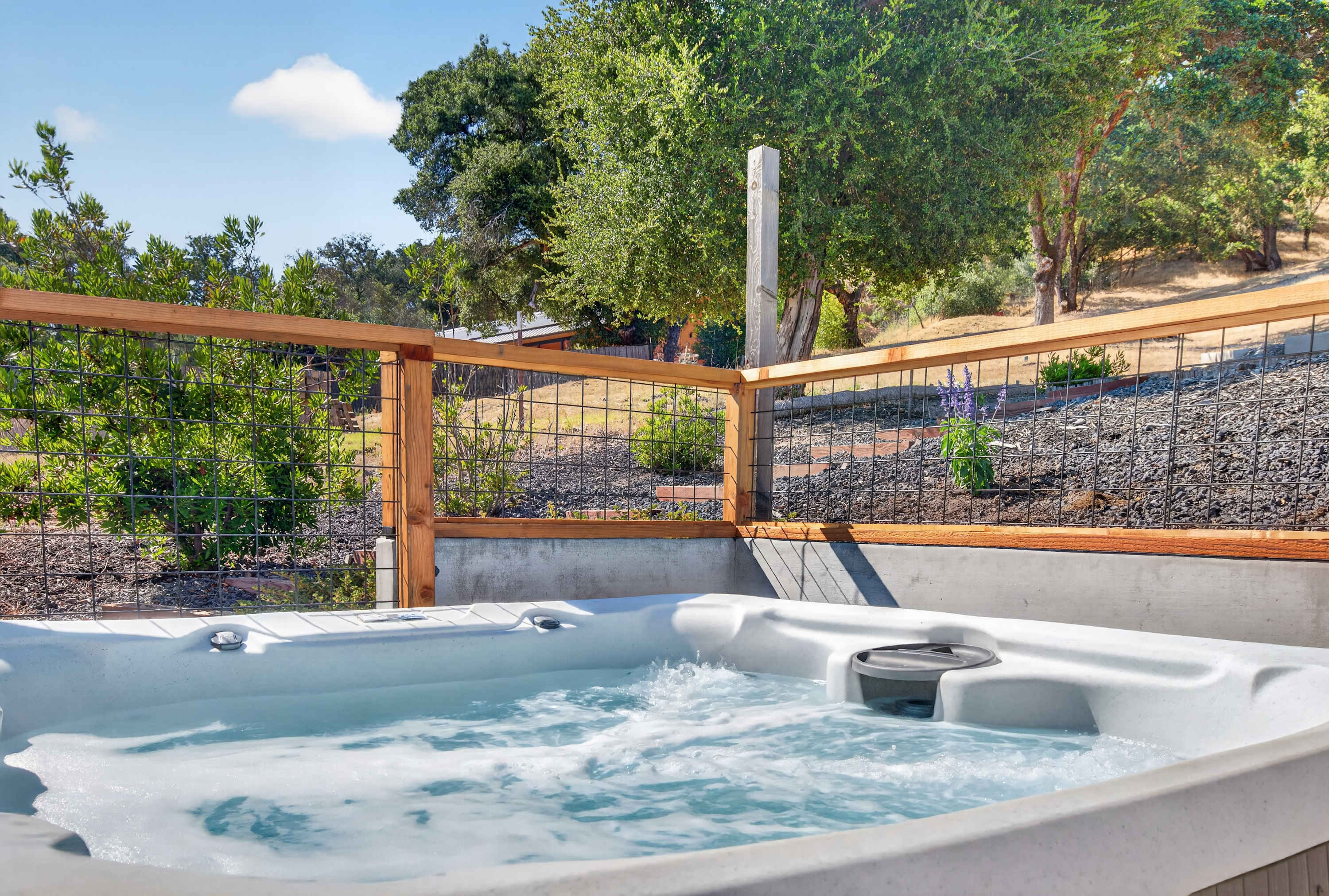 Ease into the bubbling hot tub after a day of tastings, surrounded by oaks, open sky, and Sonoma hillside quiet.