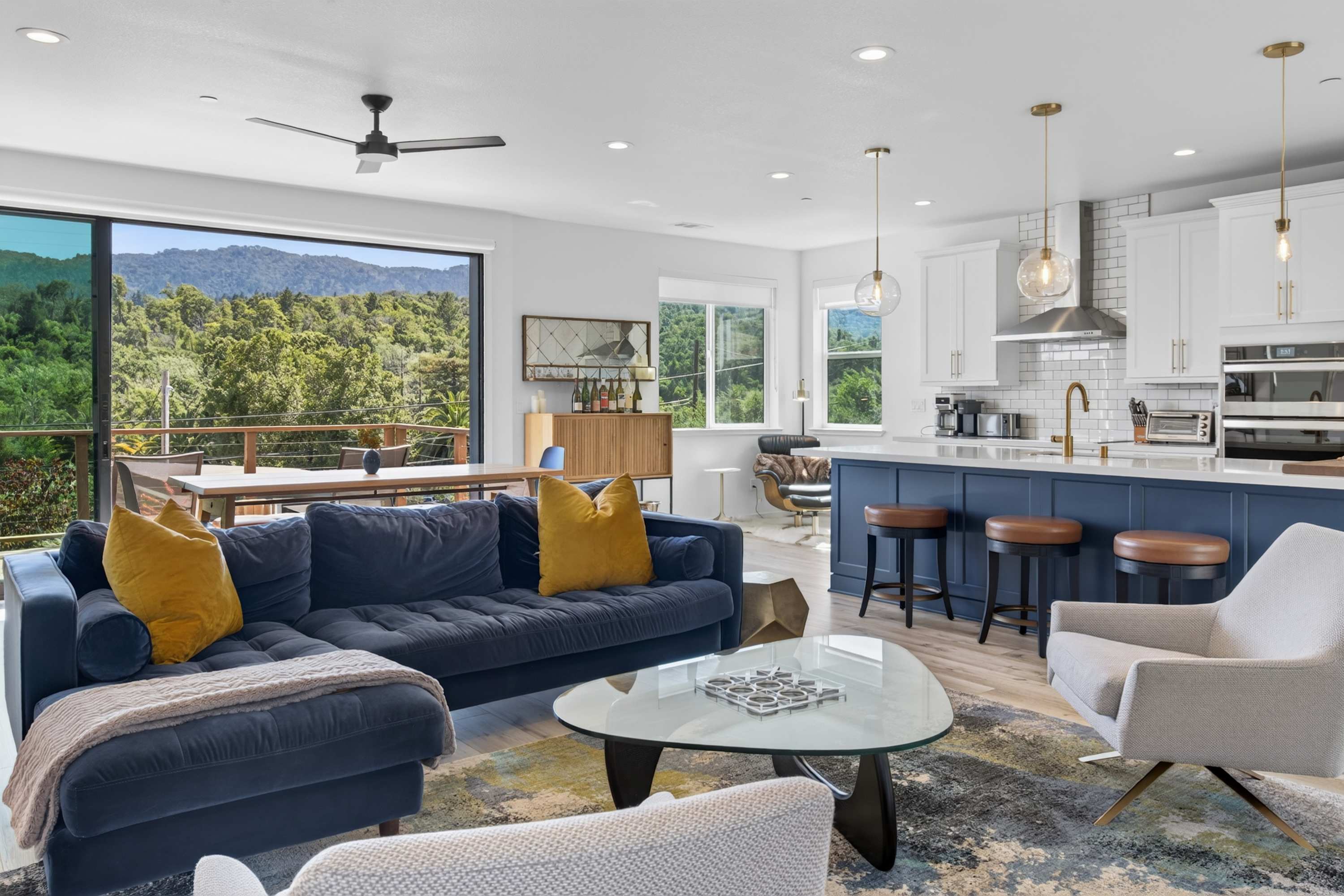 Sink into the velvet sectional as morning light spills across the open great room and rolling hillside views fill the picture window.