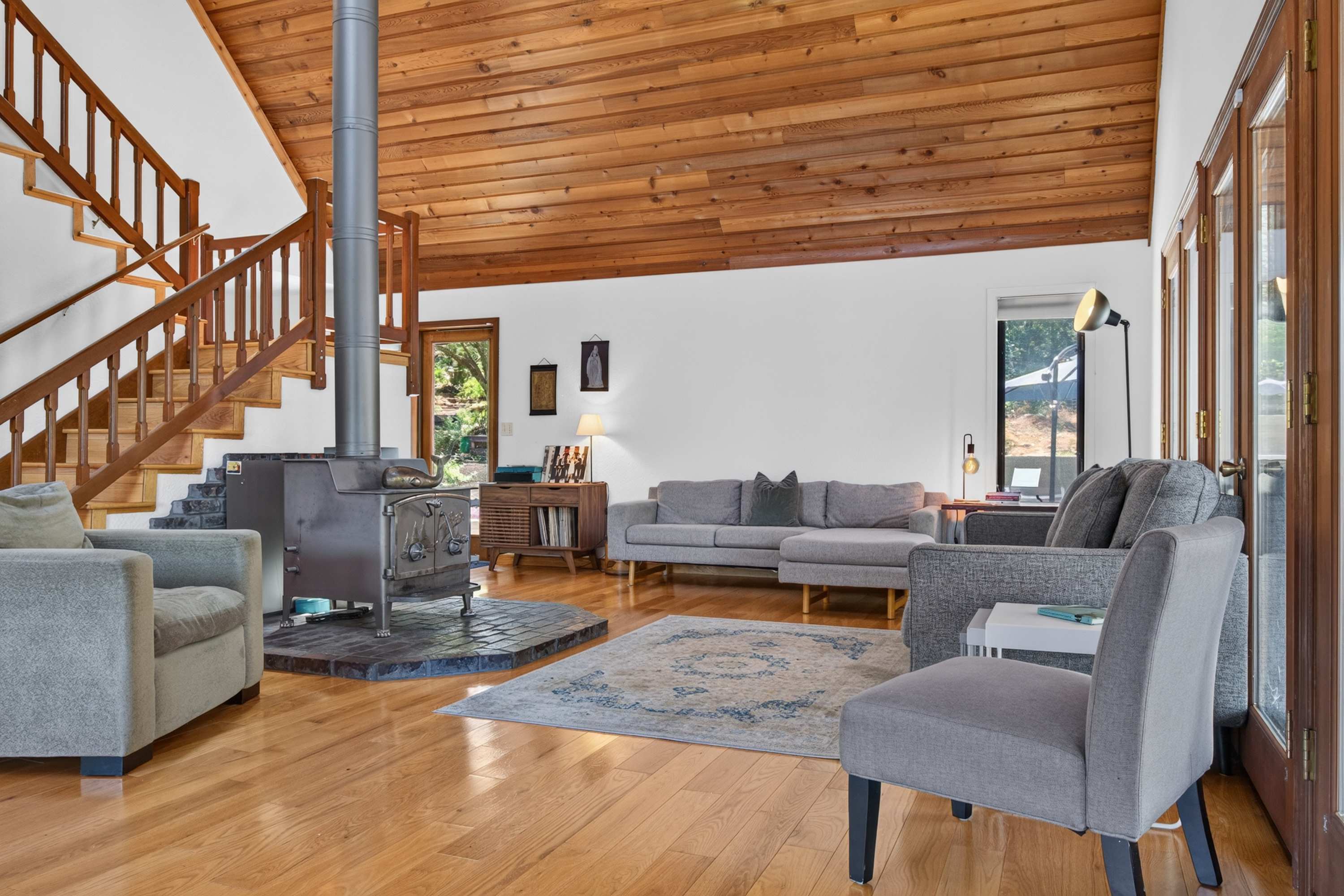 Spin a record and sink into the sectional as the wood stove crackles beneath soaring cedar-plank ceilings.