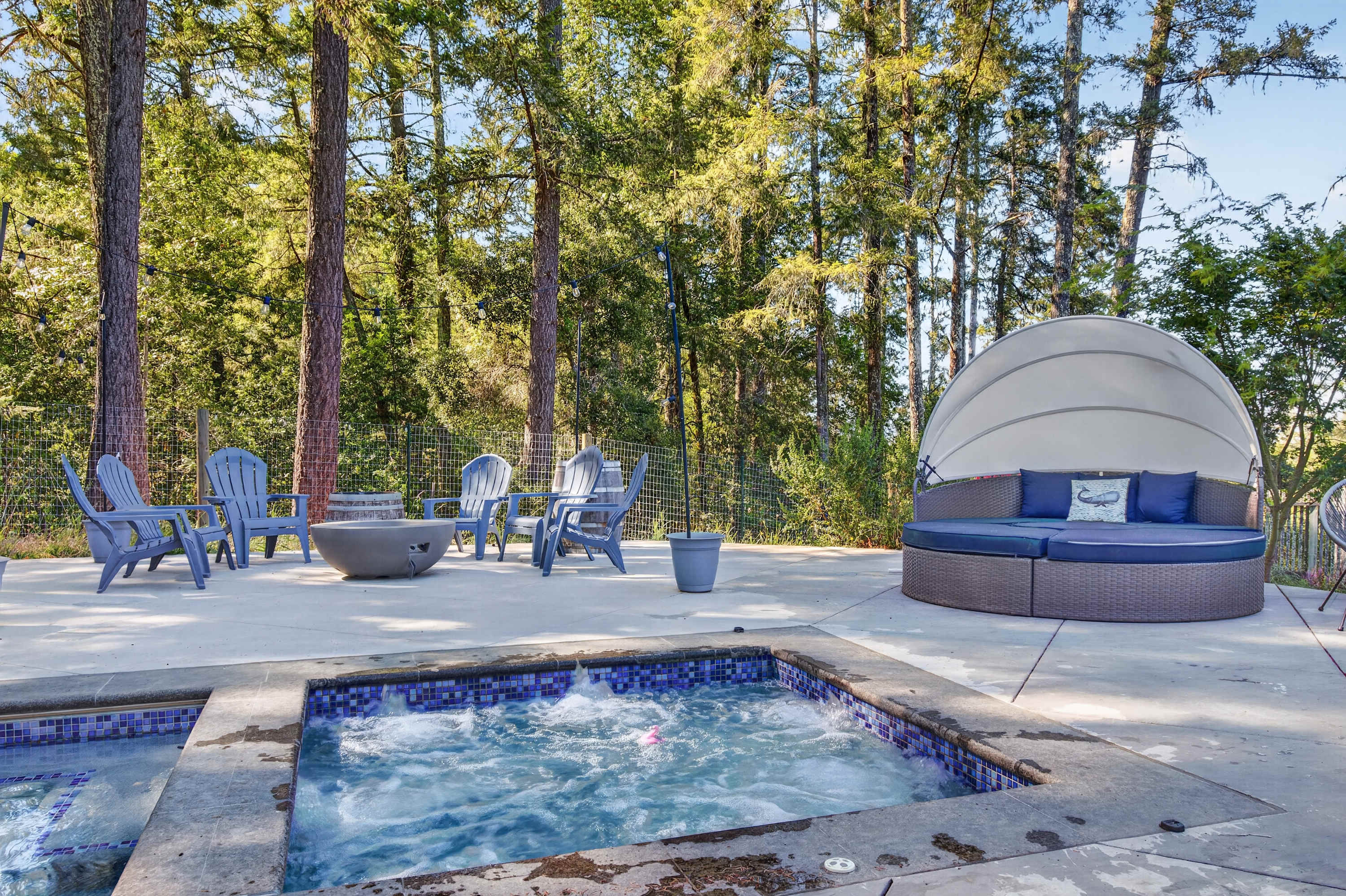 Slip into the tiled spa, then dry off in the canopied daybed while string lights flicker on above the fire bowl and Adirondacks.