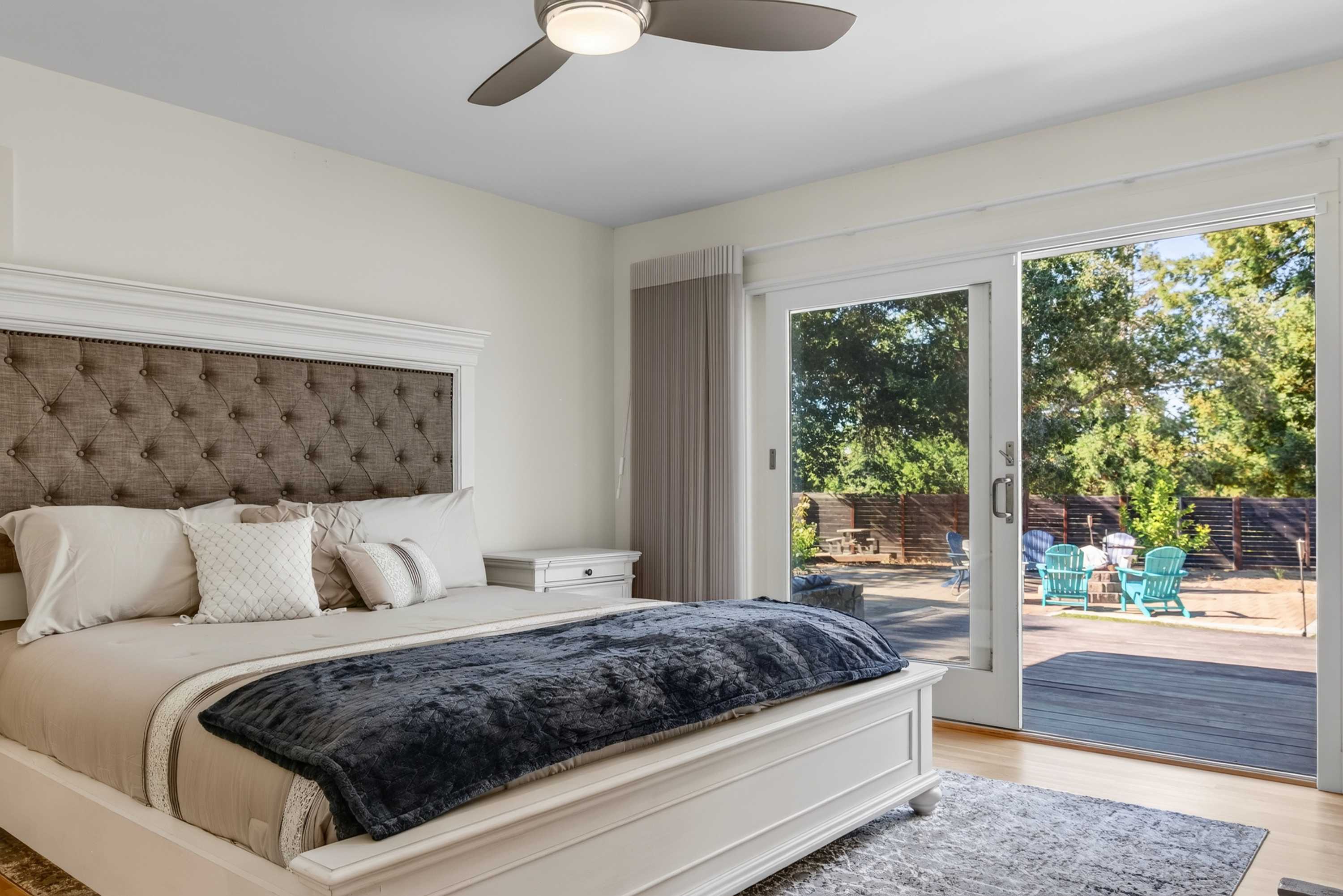 Wake in the primary suite and step through sliding doors onto the patio, where blue Adirondack chairs wait under the Sebastopol sun.