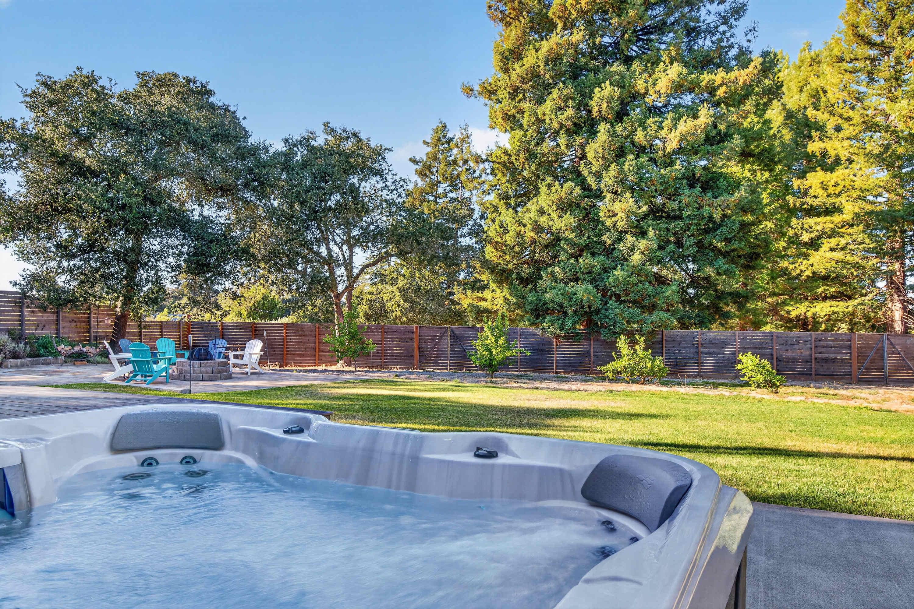 The Gravenstein opens to a private backyard where you can soak in the hot tub and look out over the lawn and tree-lined fence.