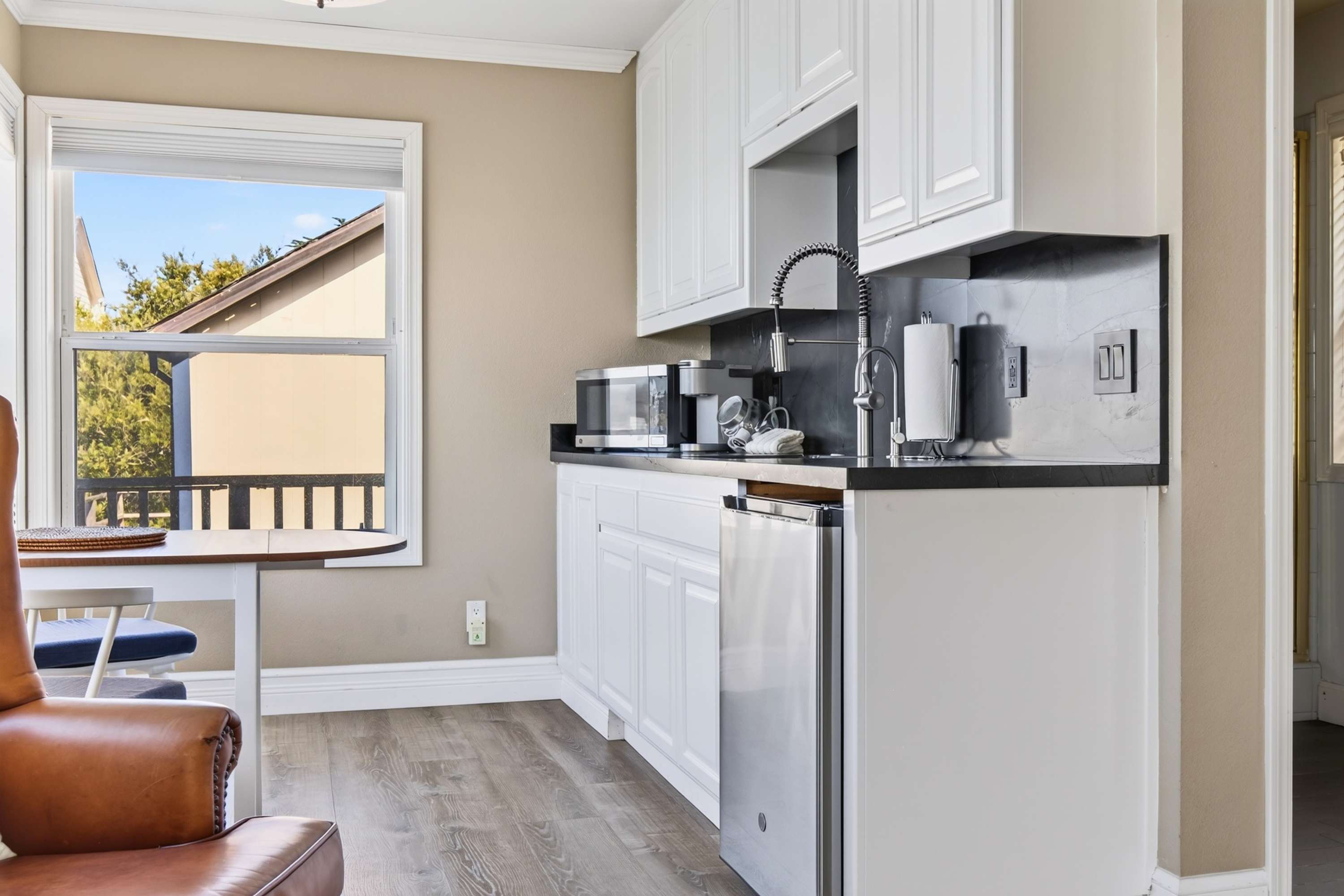Brew at the Keurig, stash snacks in the mini fridge, and pull a chair up to the dark stone counter for a bay-side breakfast.