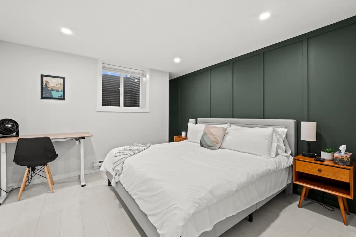 Bedroom with a standing desk in the Rockland Park suite
