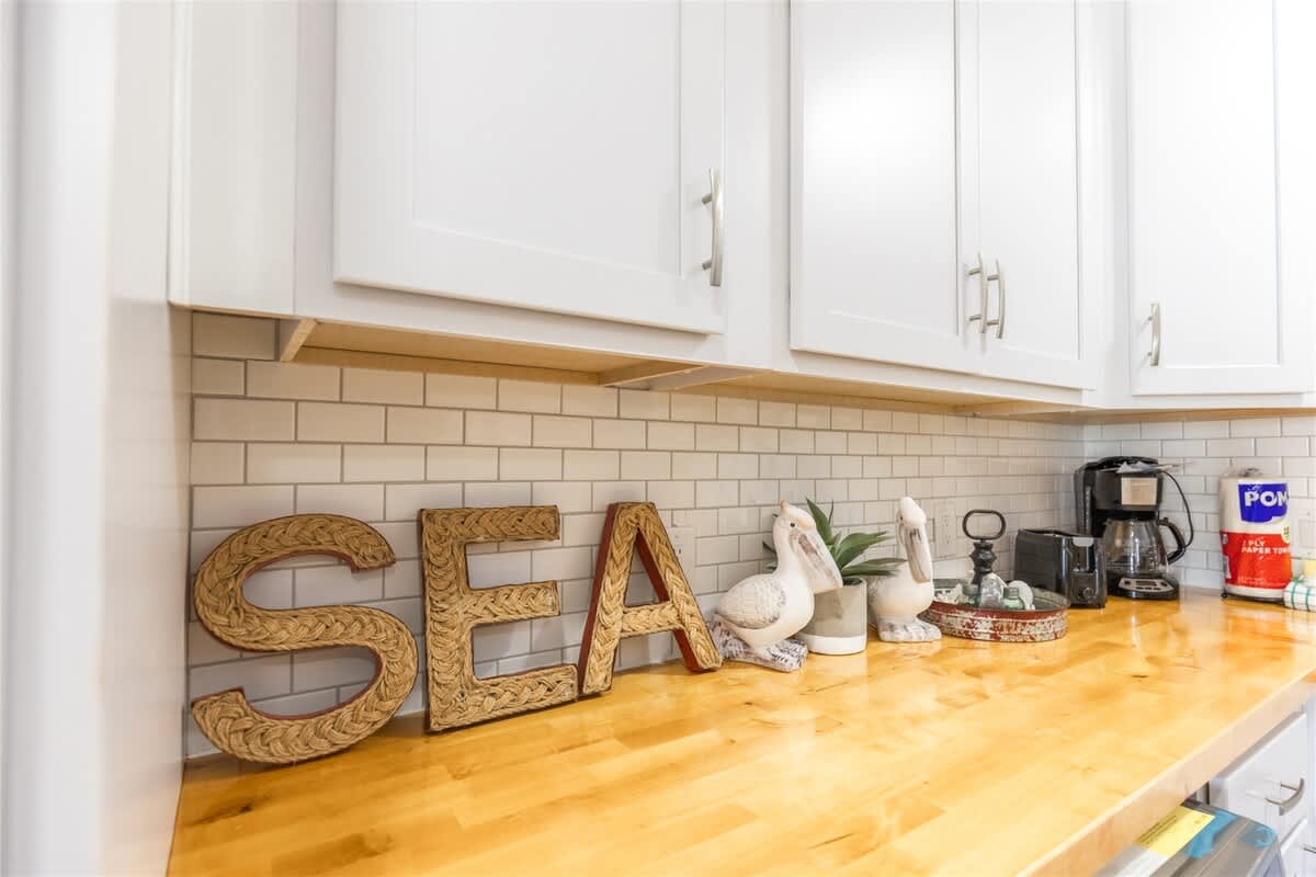 The Summit 504 – Kitchen countertop with decorative elements, coffee maker, and backsplash tiles.