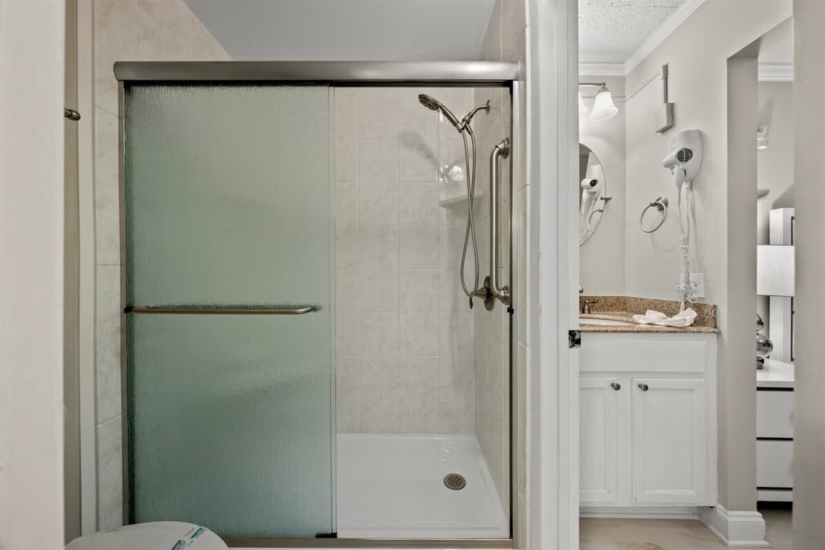 The Summit 816 – Bathroom featuring a glass shower, vanity with sink, and modern fixtures.