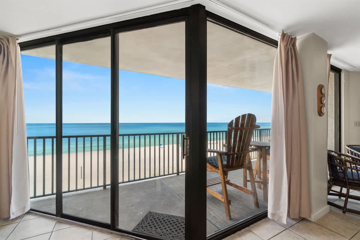 Aquavista 405e – Ocean view from balcony with seating area and sliding glass doors in a vacation rental.