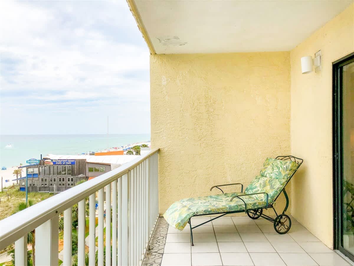 The Summit 611 – Balcony with a lounge chair, ocean view, and beach access below.