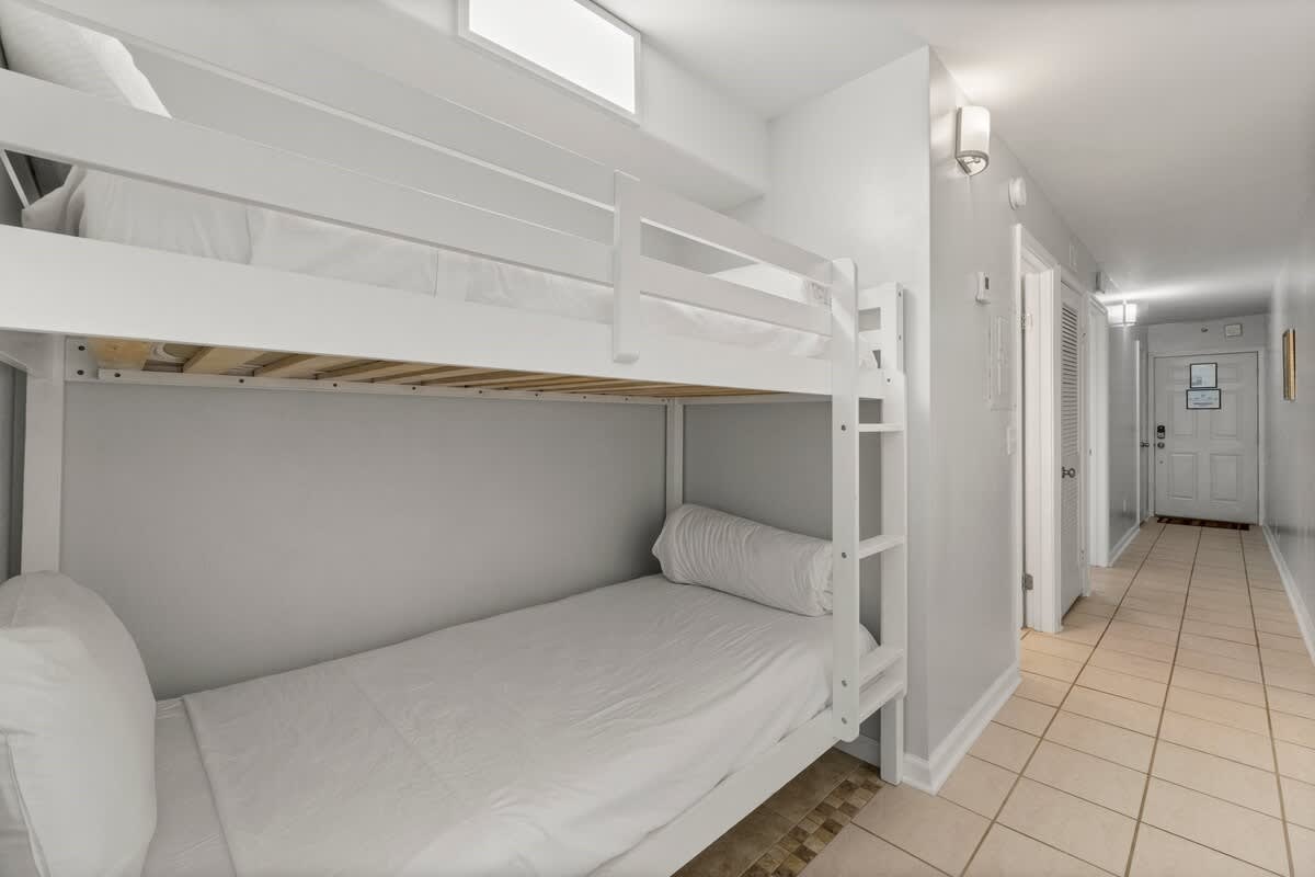 The Summit 620 – Bunk beds in a small hallway area with tile flooring and a door to an entrance.