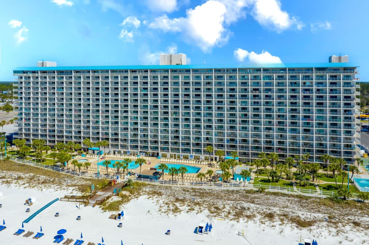 The Summit 620 – Aerial view of The Summit 620, a beachfront building with multiple floors and a pool area.